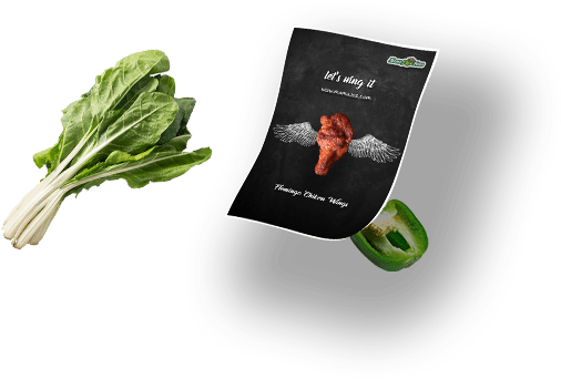 A package of fresh vegetables alongside a book featuring a heart symbol on its cover.