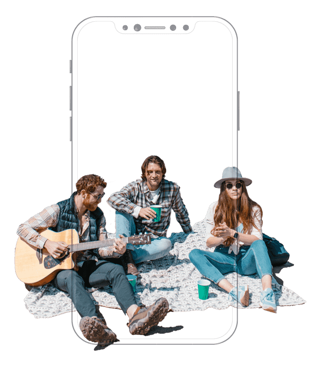 Three individuals seated on a blanket, one playing guitar while the others engage with a cell phone.