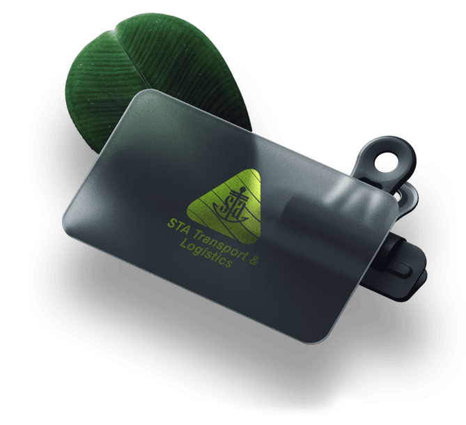 A vibrant green leaf rests beside a black card featuring a striking green triangle design.