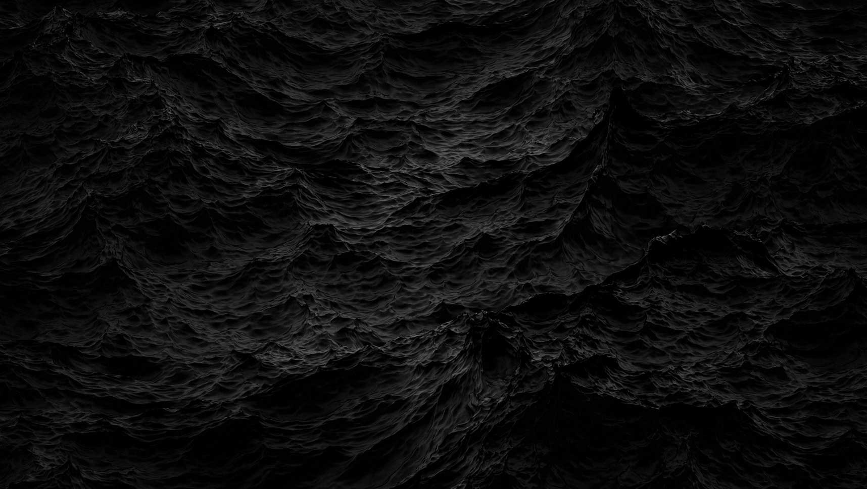 A black background featuring numerous dark waves, creating a sense of depth and movement.