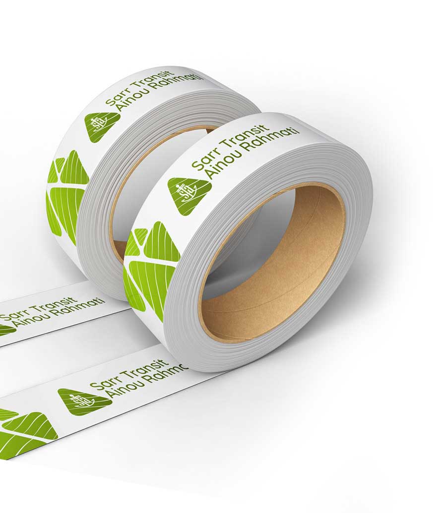 Two rolls of white and green tape featuring a prominent logo, displayed side by side on a neutral background.